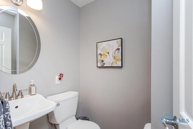 bathroom featuring toilet and sink