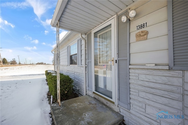 view of snow covered property entrance