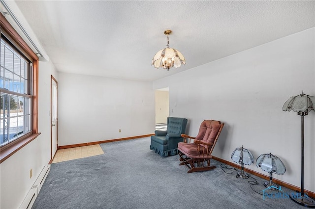 sitting room with light colored carpet, a notable chandelier, and baseboard heating