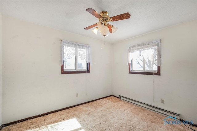 carpeted empty room with a baseboard radiator and ceiling fan