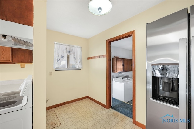 kitchen featuring washer and dryer, stainless steel fridge, and white range with electric cooktop