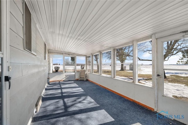 sunroom / solarium with wooden ceiling, lofted ceiling, and a wealth of natural light