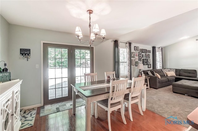 dining space with a notable chandelier and hardwood / wood-style flooring