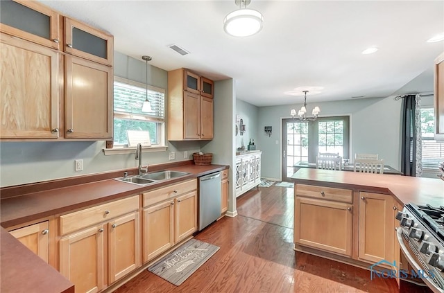 kitchen with pendant lighting, sink, dark hardwood / wood-style flooring, and appliances with stainless steel finishes