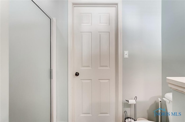 bathroom with walk in shower and toilet