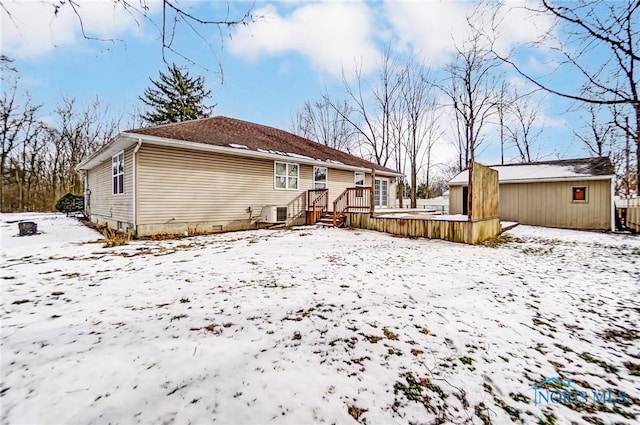 view of snow covered back of property