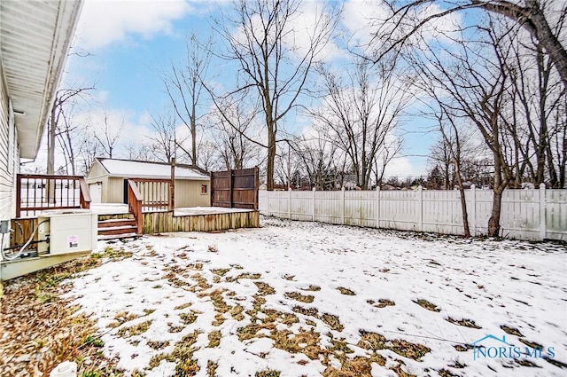 snowy yard featuring a deck