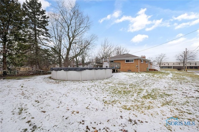 snowy yard with a covered pool