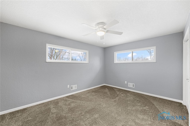 empty room featuring carpet floors, a textured ceiling, and ceiling fan