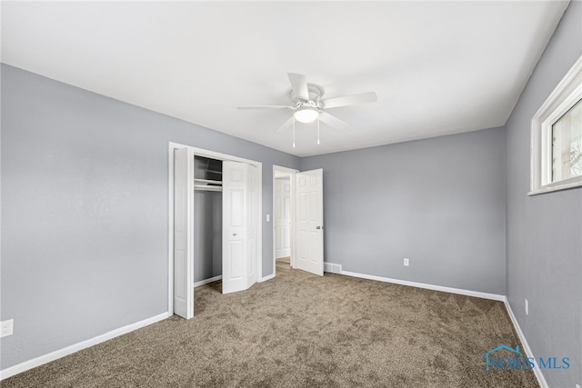 unfurnished bedroom with carpet floors, a closet, and ceiling fan