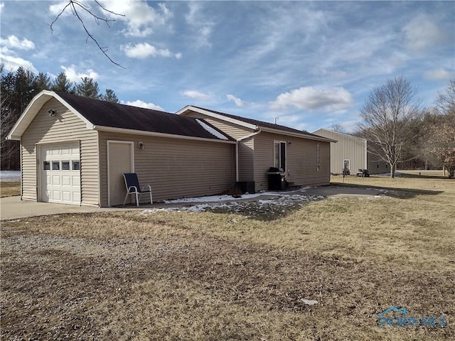 view of home's exterior with a garage and a yard