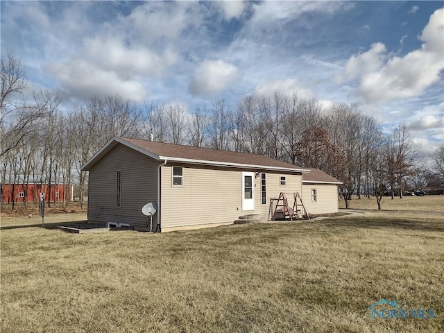 rear view of property with a yard