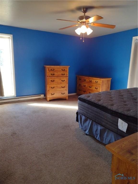 carpeted bedroom featuring ceiling fan and baseboard heating