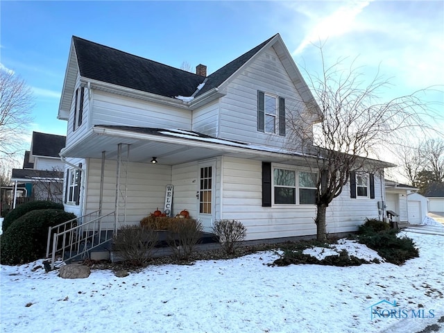 view of front of property with a porch and a garage