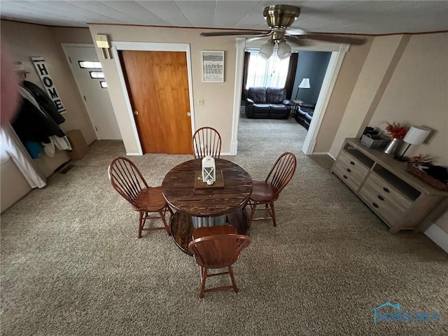 dining area featuring carpet flooring and ceiling fan