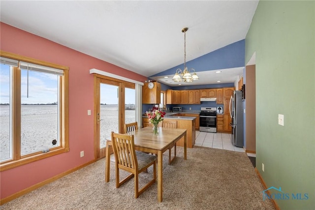 dining space featuring lofted ceiling, a water view, light colored carpet, and a notable chandelier