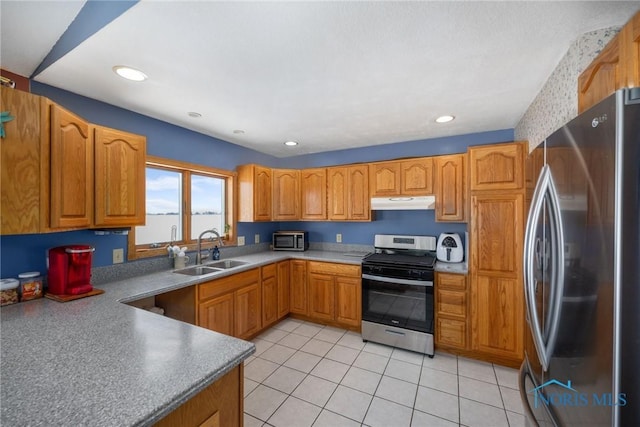 kitchen featuring light tile patterned floors, stainless steel appliances, and sink