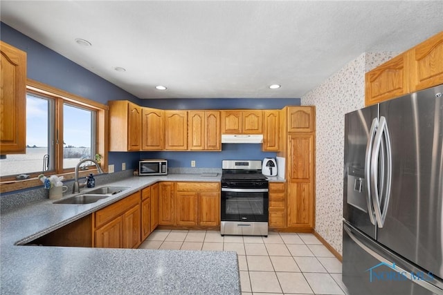 kitchen featuring appliances with stainless steel finishes, sink, and light tile patterned floors