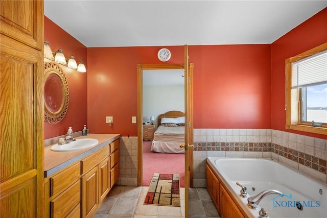 bathroom with vanity, tile patterned flooring, and a bathtub