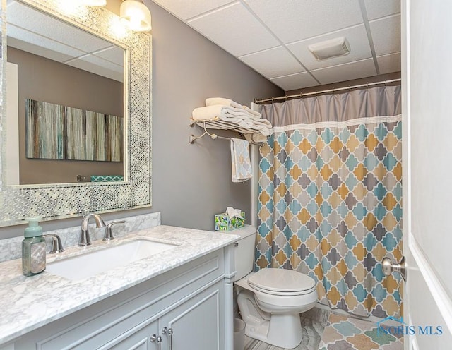 bathroom with vanity, a paneled ceiling, toilet, and a shower with shower curtain