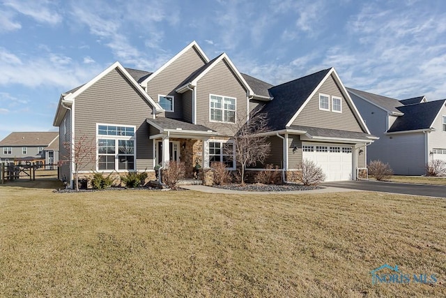 view of front of property with a garage and a front lawn