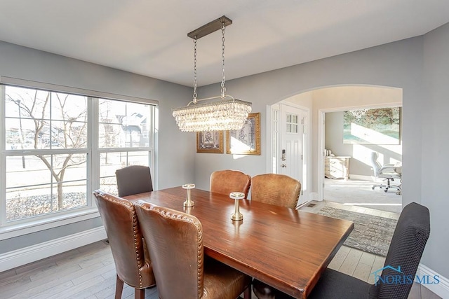 dining room with light hardwood / wood-style floors and a chandelier