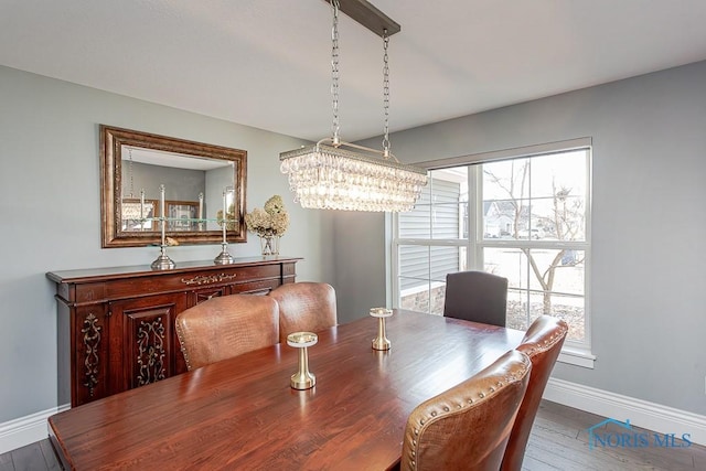 dining room with hardwood / wood-style flooring, a chandelier, and a healthy amount of sunlight