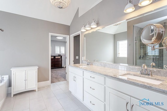 bathroom featuring vanity, a shower with door, tile patterned flooring, and vaulted ceiling