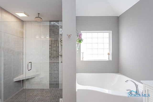 bathroom featuring plus walk in shower and vanity