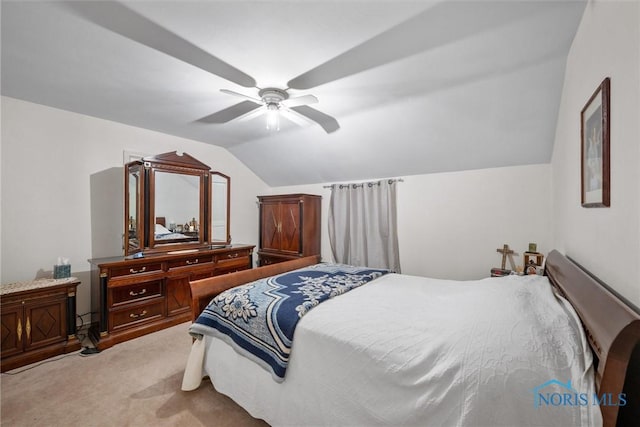 bedroom with vaulted ceiling, carpet flooring, and ceiling fan