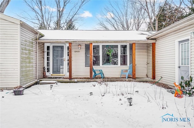 view of snow covered property entrance