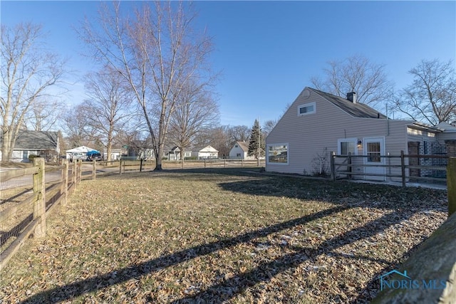 view of side of property featuring a yard