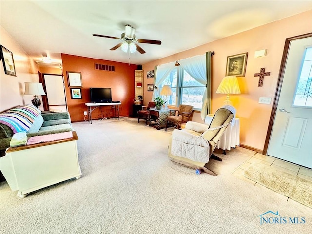 living room featuring ceiling fan and carpet