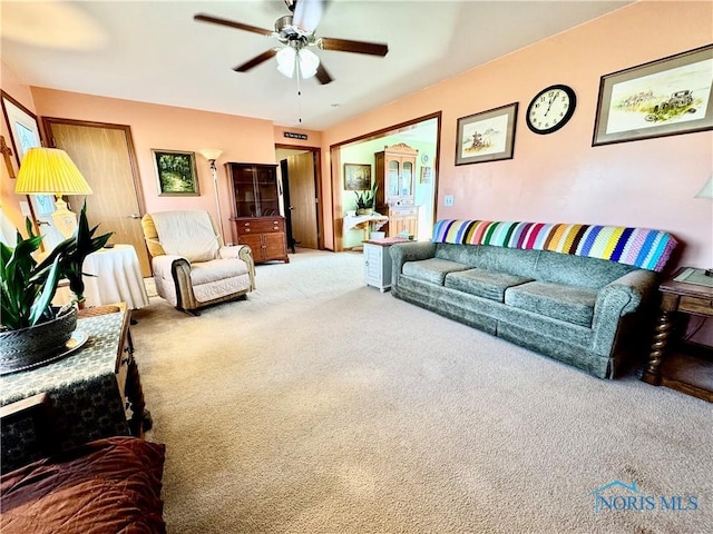 carpeted living room featuring ceiling fan