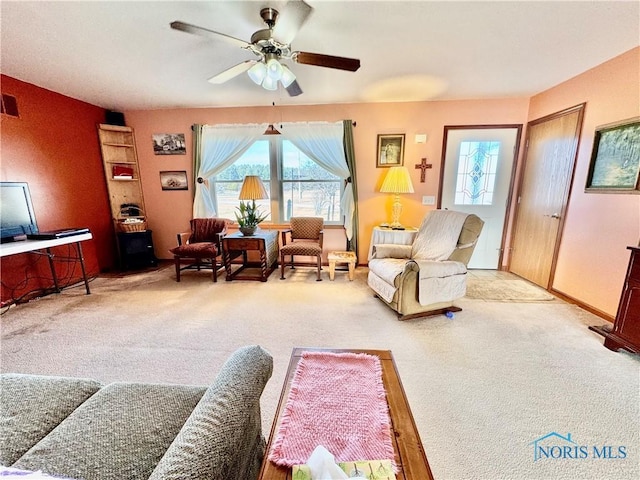 carpeted living room featuring ceiling fan