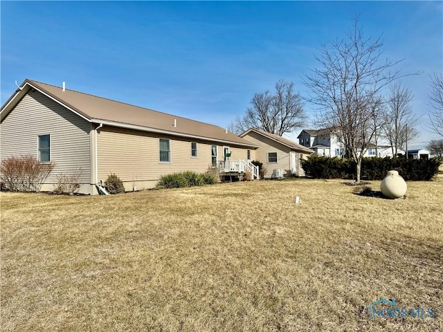 rear view of property featuring a lawn