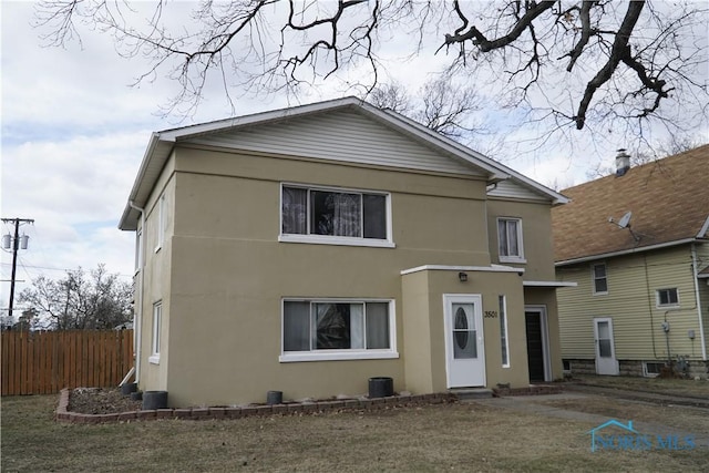 rear view of house with a yard