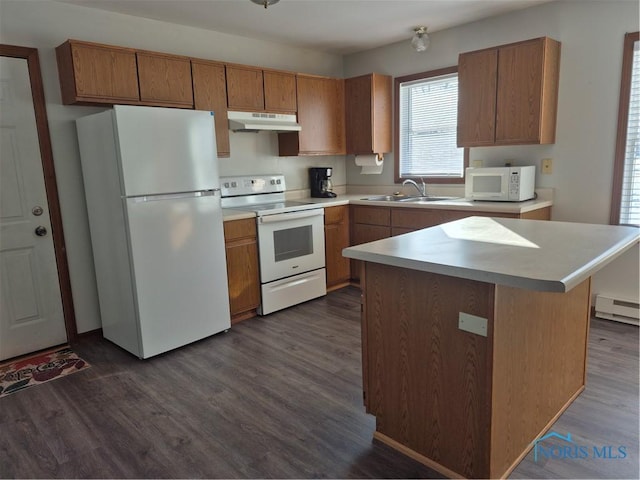 kitchen with dark wood-type flooring, sink, baseboard heating, a kitchen island, and white appliances