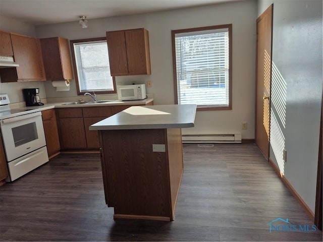 kitchen with sink, a baseboard heating unit, a center island, dark wood-type flooring, and white appliances