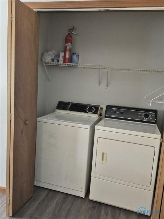 clothes washing area featuring washer and dryer and dark hardwood / wood-style floors