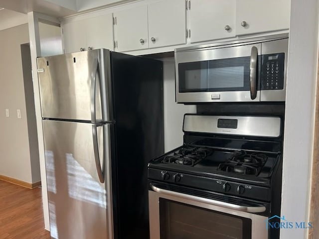 kitchen featuring light hardwood / wood-style flooring, white cabinets, and appliances with stainless steel finishes