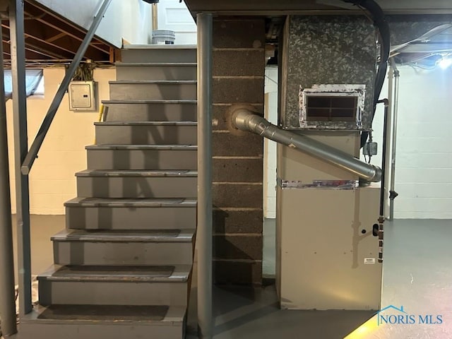 staircase with concrete flooring