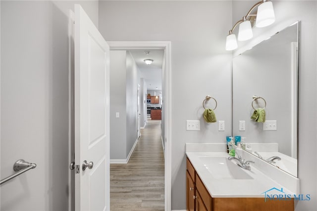 bathroom with hardwood / wood-style flooring and vanity