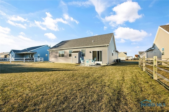 back of property with a patio and a lawn