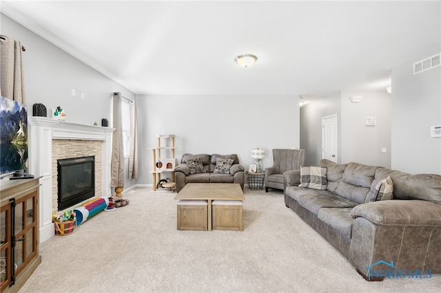 living room with light colored carpet and a fireplace