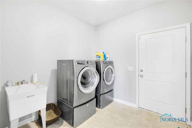 laundry room featuring sink and washer and clothes dryer