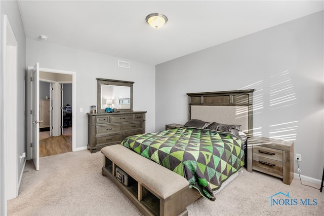 bedroom featuring light carpet