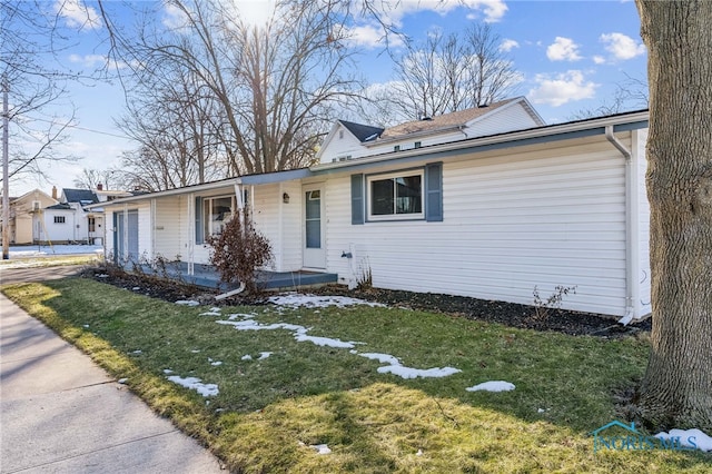 view of front of home with a front yard and covered porch