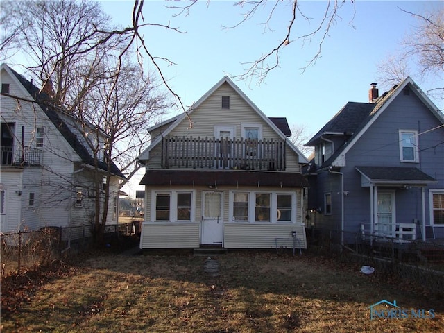 back of property with a balcony