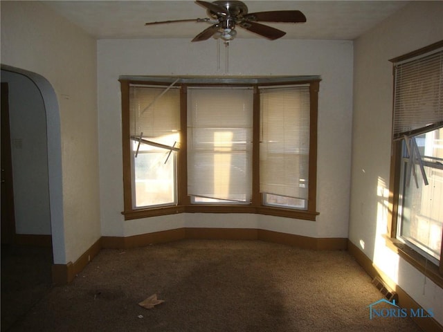 spare room featuring carpet floors and ceiling fan